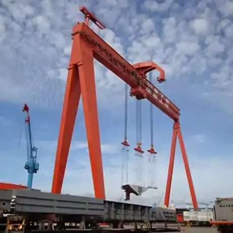 Heavy-duty shipbuilding gantry crane working in marine manufacturing facility